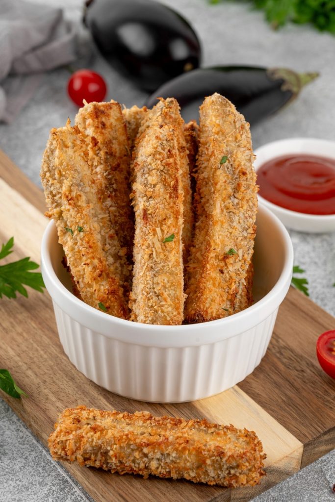 Sticksuri de vinete în crustă de pesmet cu parmezan și un bol cu sos